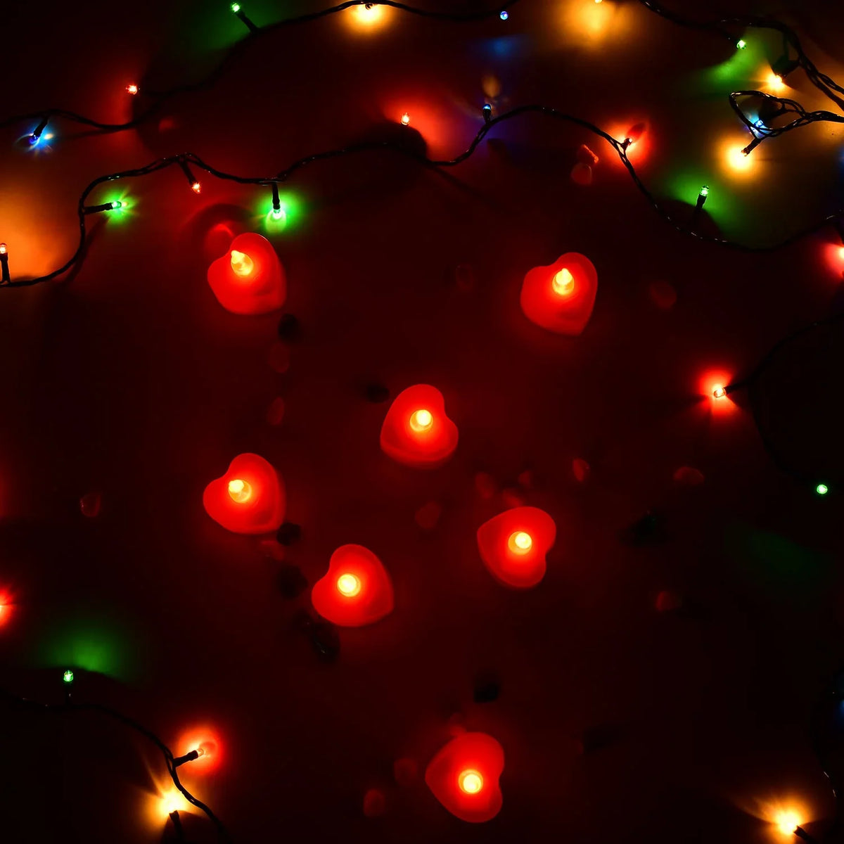 Overhead view of glowing multi-color LED Heart Diya Candles.