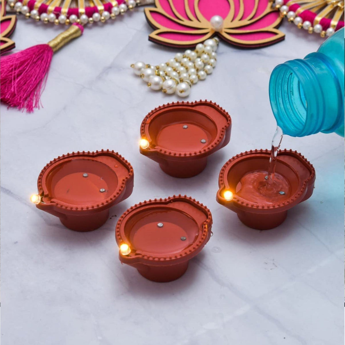 Close-up of a water sensor diya being activated by a drop of water.